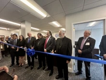 Papal nuncio Cardinal Christophe Pierre (center) leads a ribbon-cutting ceremony at the Society of St. Vincent de Paul USA’s new advocacy office on Capitol Hill on Friday, April 4, 2025.