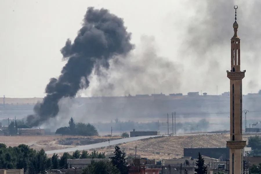 Smoke rises over the Syrian town of Tel Abyad on the Turkish border Oct. 13, 2019. ?w=200&h=150