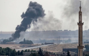 Smoke rises over the Syrian town of Tel Abyad on the Turkish border Oct. 13, 2019.   Burak Kara/Getty Images
