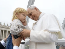 Pope Leo XIV greets a young child before his Wednesday general audience in St. Peter’s Square on Sept. 10, 2025.