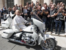 Pope Leo XIV poses on a custom BMW R 18 papal motorcycle gifted to him by the Christian Jesus Bikers at the Vatican, Wednesday, Sept. 3, 2025.