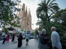 Tourists take photos as they visit the Sagrada Familia basilica in Barcelona on Aug. 2, 2025.
