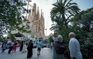 Tourists take photos as they visit the Sagrada Familia basilica in Barcelona on Aug. 2, 2025. Credit: Manaure QUINTERO/AFP