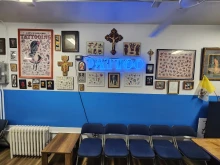 Catholic images and crucifixes fill the walls in Times Square Tattoo.