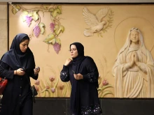 Iranian women walk in front of a relief sculpture of the Virgin Mary at the newly-opened Maryam Moghaddas (Virgin Mary) metro station near the Sarkis Cathedral of the Armenians in Tehran on Oct. 18, 2025.