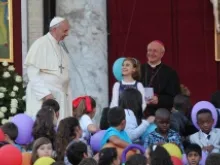 Pope Francis greets families of pilgrims Oct. 26 in St. Peter's Square. 