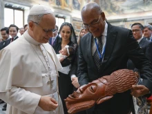 Pope Leo XIV views a gift from an attendee at the International Catholic Legislators Network meeting at the Vatican, Saturday, Aug. 23, 2025.