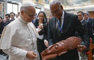 Pope Leo XIV views a gift from an attendee at the International Catholic Legislators Network meeting at the Vatican, Saturday, Aug. 23, 2025. Credit: Vatican Media