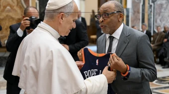 Film director Spike Lee gives Pope Leo XIV a customized New York Knicks jersey at the Vatican on November 15, 2025.