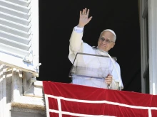 Pope Leo XIV waves to those gathered in St. Peter’s Square to pray the Angelus and listen to his Sunday message on Sept. 21, 2025.