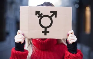 Woman holding transgender sign. Via Shutterstock. 