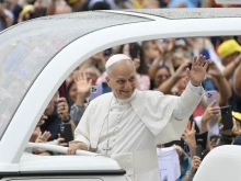 Pope Leo XIV waves at the crowds of people who braved a rainy morning for the general audience in St. Peter’s Square on Sept. 10, 2025.