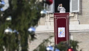 Pope Leo XIV greets pilgrims gathered in St. Peter's Square at the Vatican for the recitation of the Angelus on December 21, 2025.