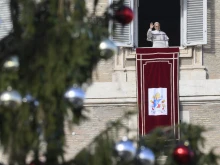 Pope Leo XIV greets pilgrims gathered in St. Peter's Square at the Vatican for the recitation of the Angelus on December 21, 2025.