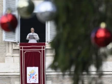 Pope Leo XIV addresses pilgrims gathered in St. Peter's Square at the Vatican for the recitation of the Angelus on December 26, 2025.