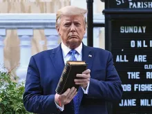  US President Donald Trump holds up a Bible outside of St John's Episcopal church across Lafayette Park in Washington, DC on June 1, 2020. 