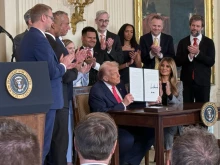President Donald Trump signs an executive order related to foster care and foster parents on Nov. 13, 2025.