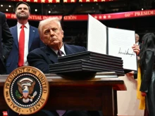 President Donald Trump holds an executive order he just signed during the inaugural parade inside Capital One Arena in Washington, D.C., on Jan. 20, 2025.