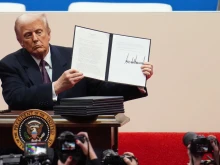 U.S. President Donald Trump holds up an executive order after signing it during an indoor inauguration parade at Capital One Arena on Jan. 20, 2025, in Washington, D.C.