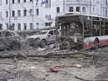 A damaged bus and vehicles after a Russian missile strike on Sumy, Ukraine, on Sunday, April 13, 2025.