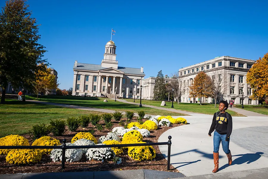 A student walks across campus at the University of Iowa, in Iowa City, Iowa.?w=200&h=150