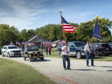 Veterans precede a motorcade for Fr. Emil Kapaun's remains outside his hometown church, St. John Nepomucene, in Pilsen, Kan., Sept. 25, 2021.
