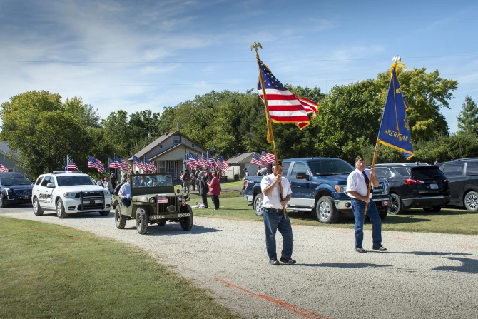 Veterans precede a motorcade for Fr. Emil Kapaun's remains outside his hometown church, St. John Nepomucene, in Pilsen, Kan., Sept. 25, 2021.