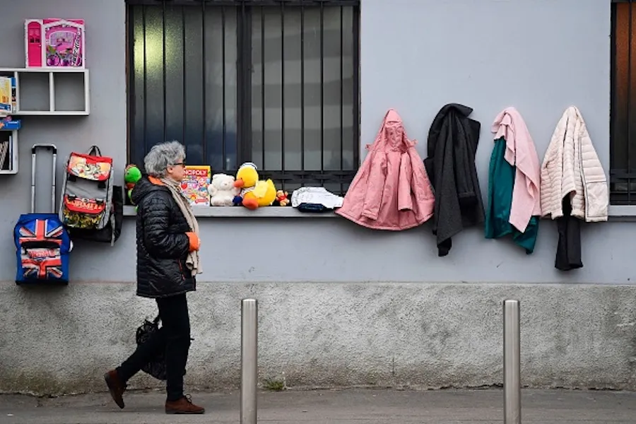  A woman walks past a "Wall of Kindness,” a charity work phenomenon, encouraging people to items such as winter clothing for the homeless, on Jan 25, 2020 in Milan. ?w=200&h=150