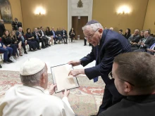 Pope Francis receives a facsimile of a 1919 letter by Adolf Hitler for the Vatican archives during an audience with a delegation of Simon Wiesenthal Center at the Vatican, June 22, 2022.