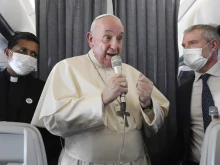 Pope Francis speaks during an in-flight press conference on the journey from Athens to Rome, Dec. 6, 2021.