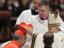 Cardinal Oscar Cantoni, bishop of Como, receives the red biretta from Pope Francis at the consistory in St. Peter's Basilica, Aug. 27, 2022.