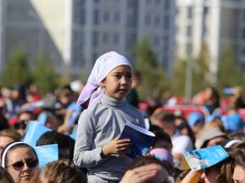 A young girl at a large outdoor Mass celebrated by Pope Francis in Kazakhstan’s capital of Nur-Sultan on Sept. 14, 2022.