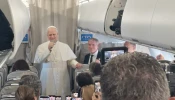 Pope Leo XIV talks to reporters during his flight to Lebanon on Nov. 30, 2025.