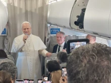 Pope Leo XIV talks to reporters during his flight to Lebanon on Nov. 30, 2025.