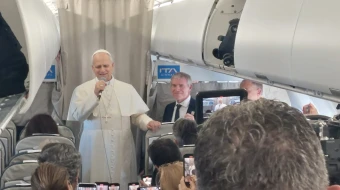 Pope Leo XIV talks to reporters during his flight to Lebanon on Nov. 30, 2025.