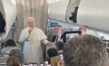 Pope Leo XIV talks to reporters during his flight to Lebanon on Nov. 30, 2025.