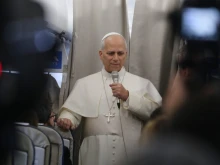 Pope Leo XIV speaks with reporters on his flight from Beirut to Rome on Dec. 2, 2025.
