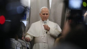 Pope Leo XIV speaks with reporters on his flight from Beirut to Rome on Dec. 2, 2025.