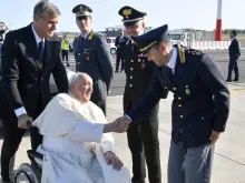 Pope Francis greets airline workers as he boards the papal plane for his four-day trip to Mongolia on Aug. 31, 2023.