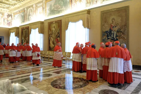 Cardinals react to Pope Benedict XVI's announcement of his intention to resign the papacy Feb. 11, 2013. The surprise announcement, which Benedict made in Latin, took place in the Hall of the Consistory in the Vatican's apostolic palace. Vatican Media