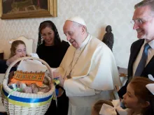 Pope Francis admires an Easter basket with Supreme Knight Patrick Kelly and his family at the Vatican, April 11, 2022.