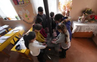 Children warming their hands over a wood-fired oven in Nagorno-Karabakh Supplied