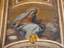 The mosaics decorating the interior dome of St. Peter’s Basilica depict the Blessed Virgin Mary next to Christ the Redeemer and the Apostles.