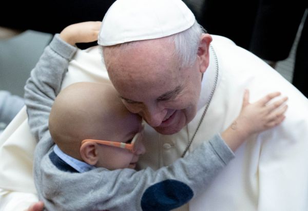 A child embraces Pope Francis at his general audience Oct. 27, 2021. Daniel Ibanez/CNA