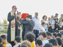 Patriarch Pierbattista Pizzaballa praying with young Catholics on the Mount of Beatitudes on July 19, 2022