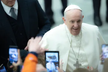 Pope Francis amid a crowd holding cell phones during his general audience in Paul VI Hall on January 26, 2022.