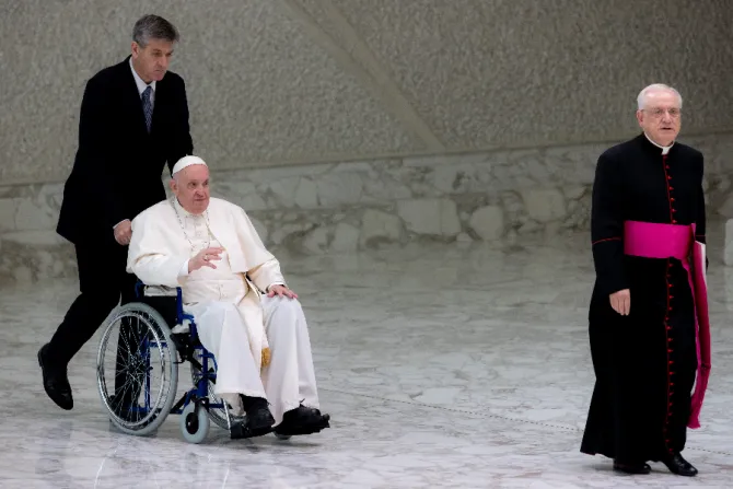 Pope Francis enters the Vatican’s Paul VI Hall in a wheelchair on May 5, 2022