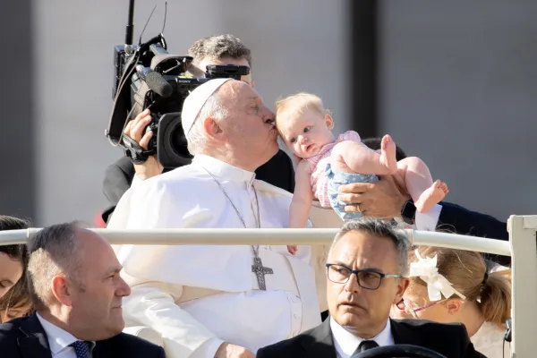Pope Francis kisses a baby before Mass for the World Meeting of Families 2022. Daniel Ibanez/CNA