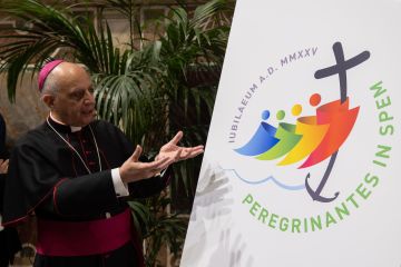 Archbishop Rino Fisichella, pro-prefect of the Dicastery for Evangelization, presents the logo for the 2025 Jubilee Year, June 28, 2022.