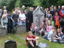 Pilgrims gather around Chesterton’s grave at Beaconsfield during July 25, 2020 pilgrimage